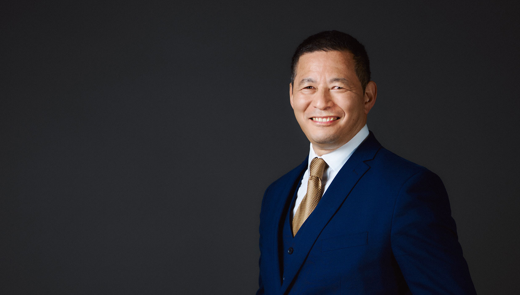 Man smiling and dressed in suit