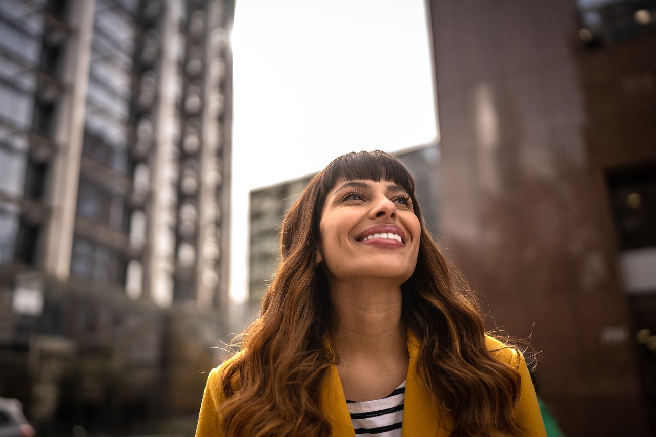 Woman smiling in the street in broad daylight